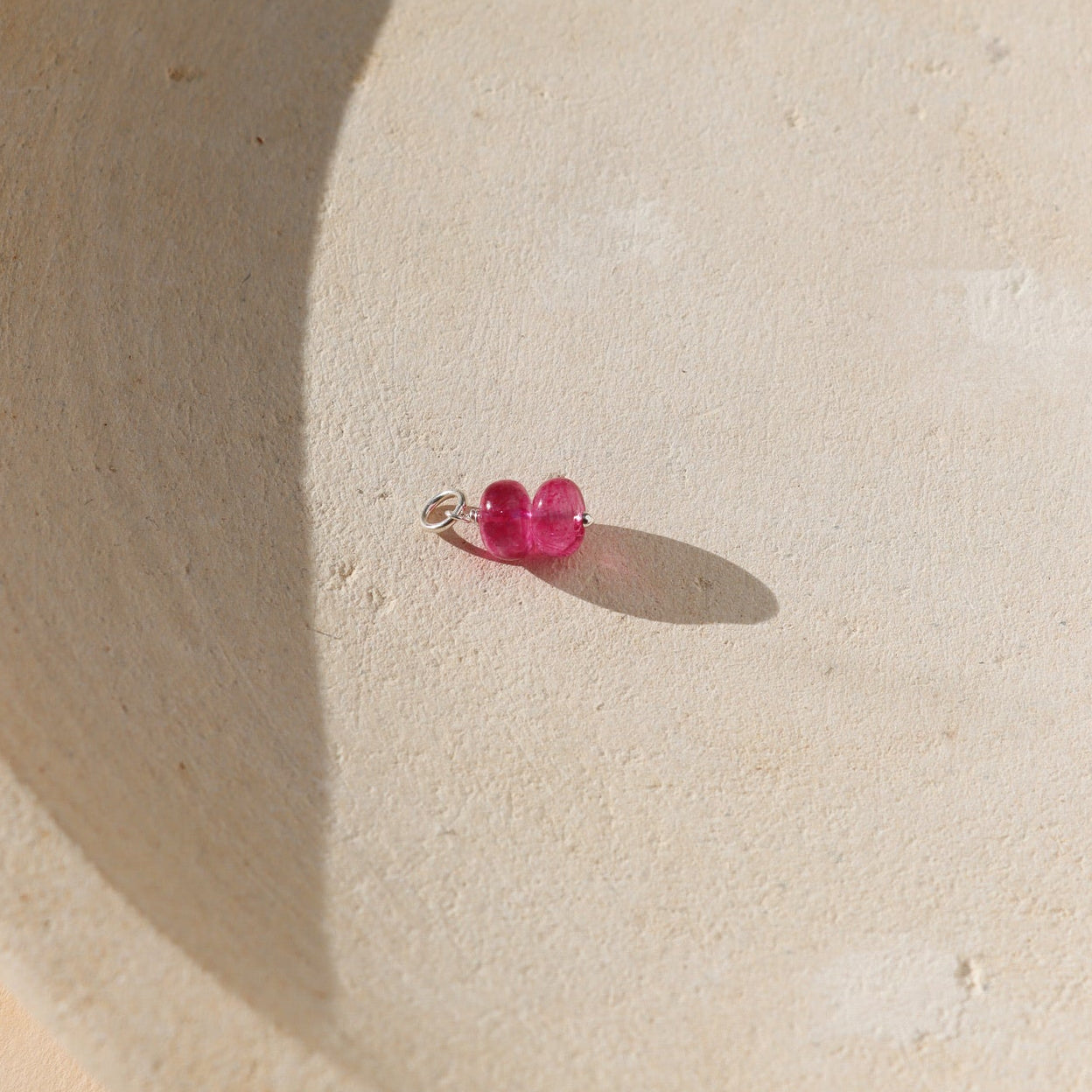 pink topaz charm with sterling silver components in sunshine