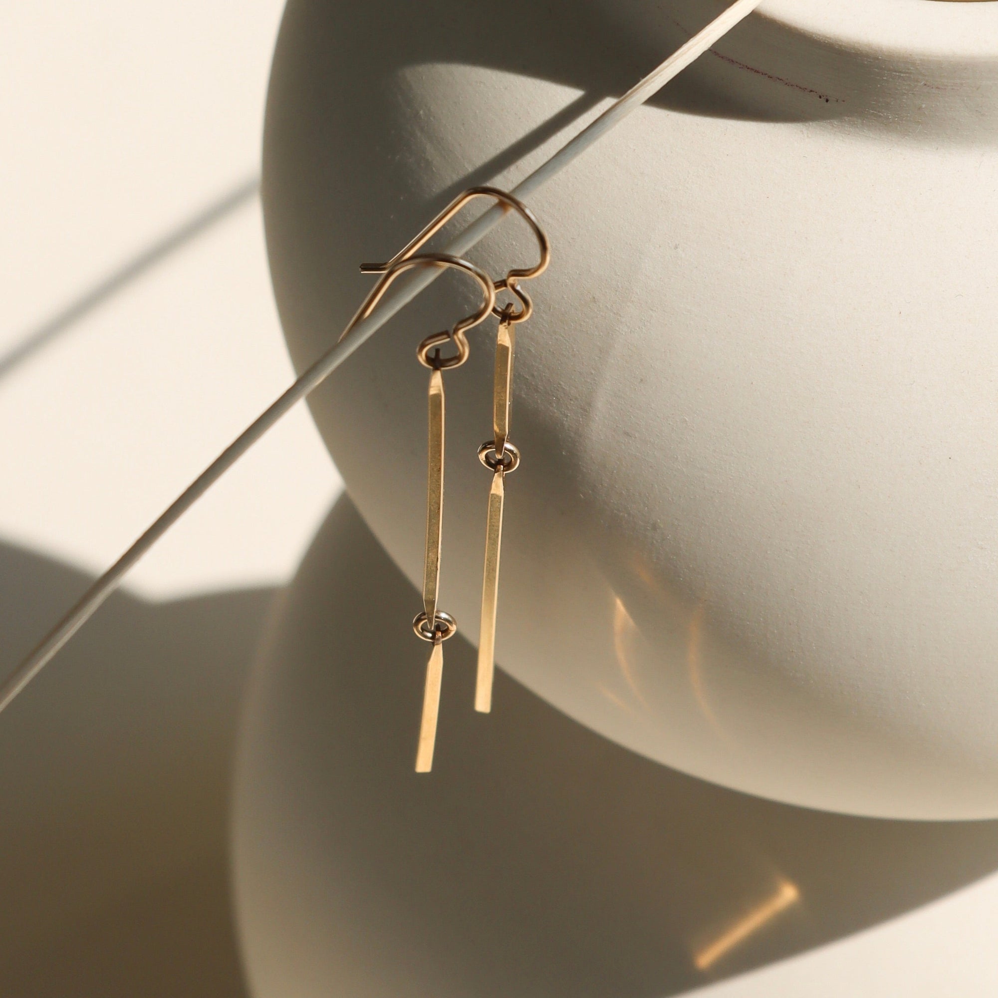 14k gold fill handmade dangle earrings in the sunlight