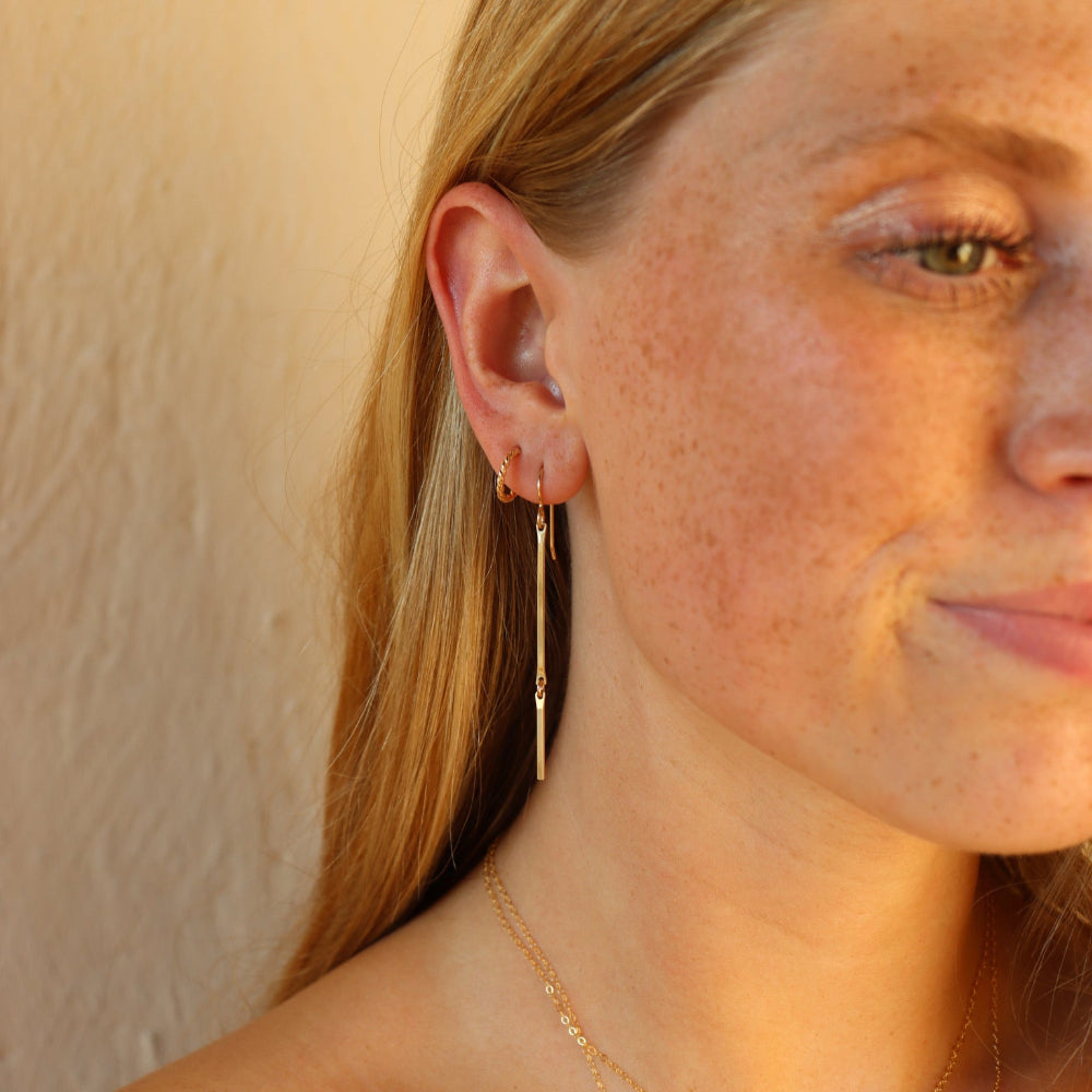 model wearing 14k gold fill dangle earrings 