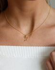 Delicate gold ribbon necklace with a minimalist bow design