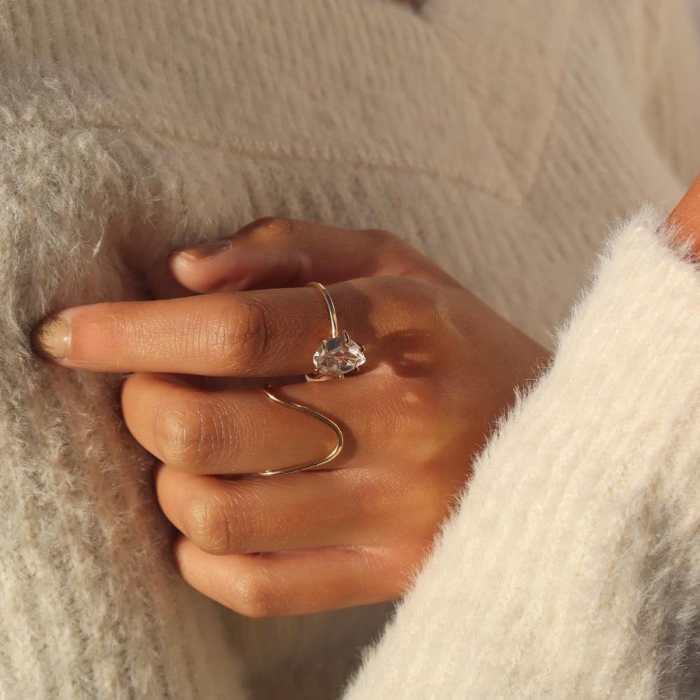 Close up of model wearing 14k gold fill rising tide ring paired with Herkimer ring
