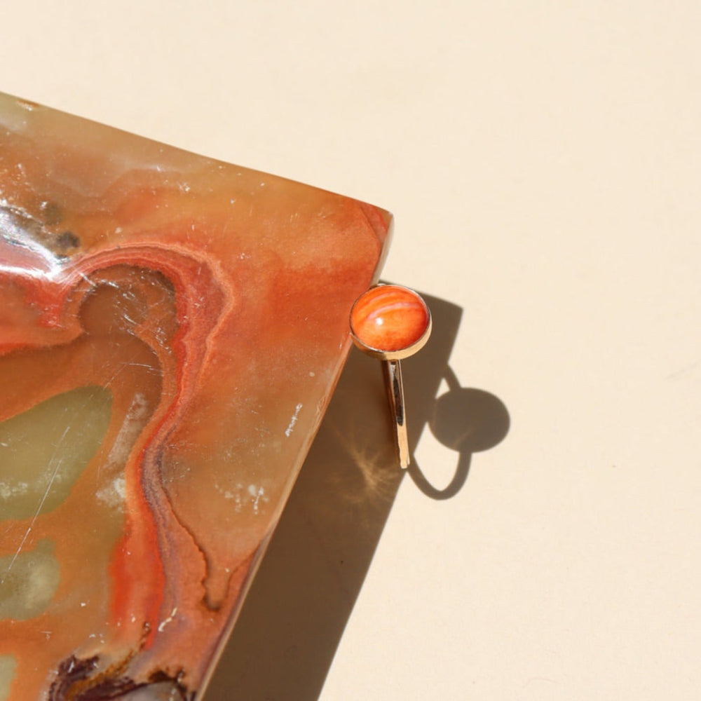 Sienna Ring featuring a vibrant spiny oyster gemstone on a hand-hammered gold filled band.
