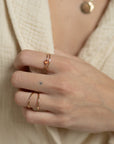 model wearing 14k gold fill skinny ring styled with tiny gemstone ring and infinity ring