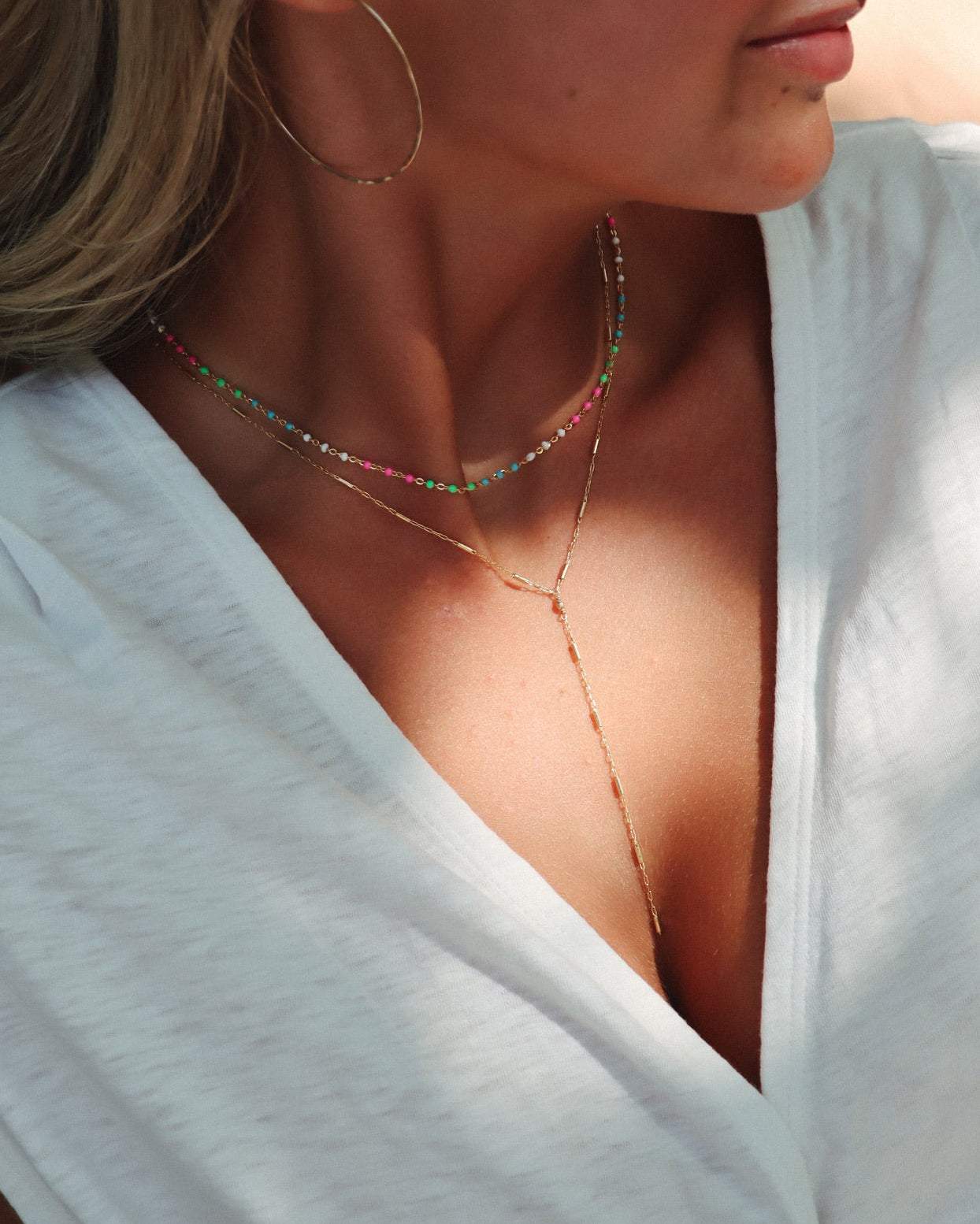 model wearing 14k gold fill chain lariat necklace with chain and enamel choker necklace