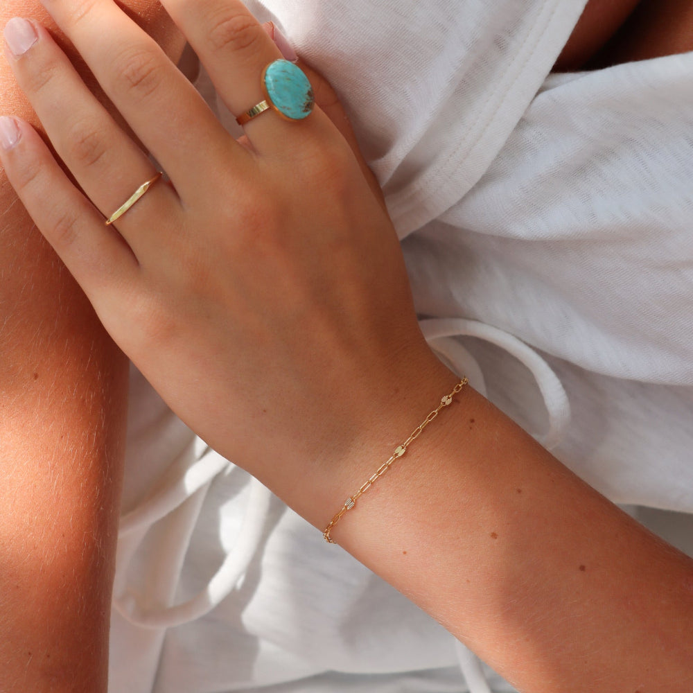 model wearing 14k gold fill chain bracelet with 14k gold fill ring featuring an oval turquoise stone