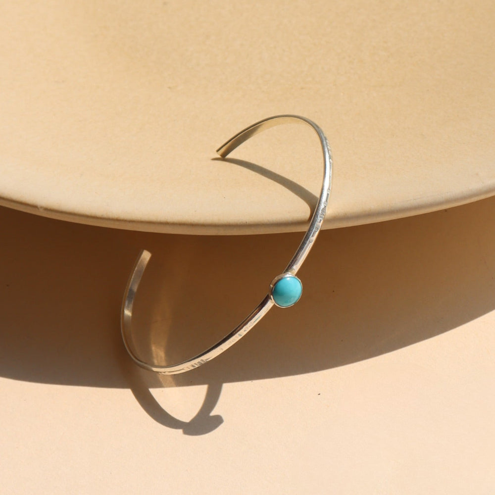 Turquoise Skyline Cuff featuring a 6mm Sleeping Beauty turquoise cabochon on a hand-notched sterling silver band.