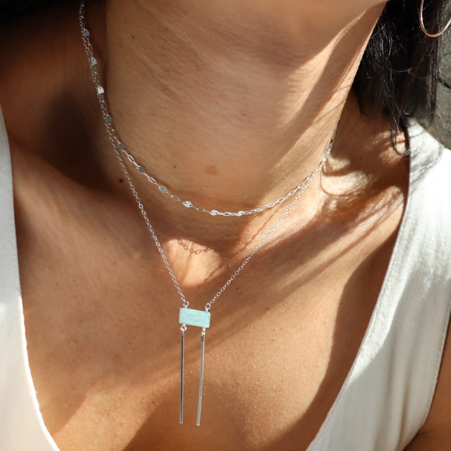 model wearing sterling silver dainty chain necklace with rectangle aquamarine bead & 2 sterling silver bars