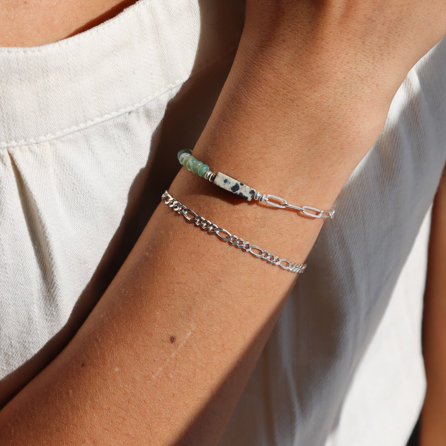 model wearing sterling silver chain bracelet with half beaded half chain bracelet