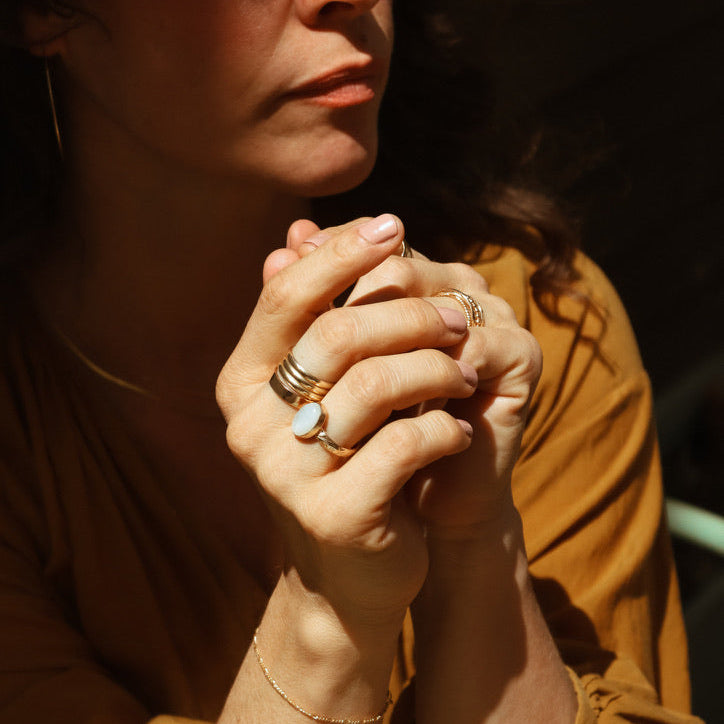 model wearing 14k gold fill rings paired with an oval moonstone