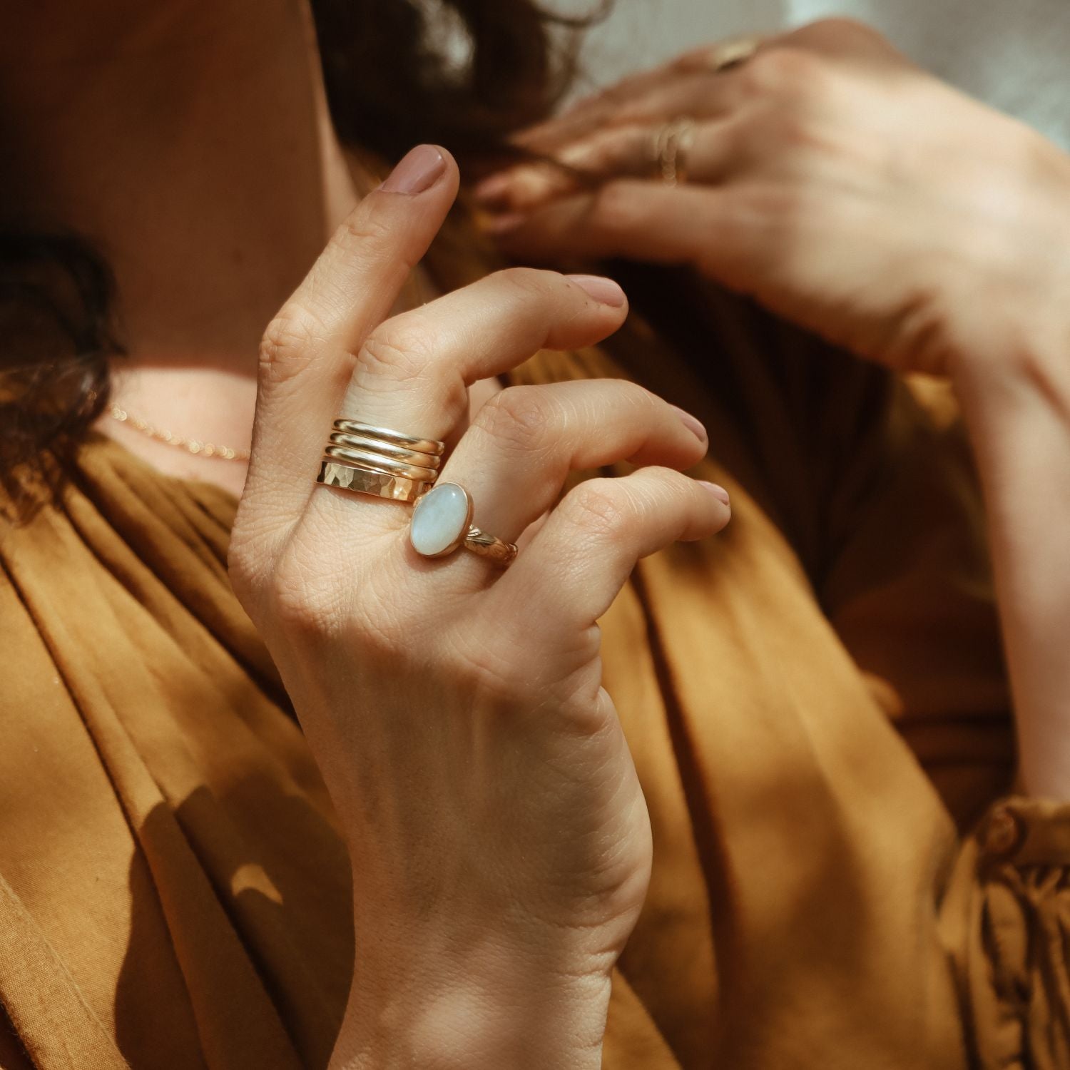 model wearing 14k gold fill rings paired with an oval moonstone