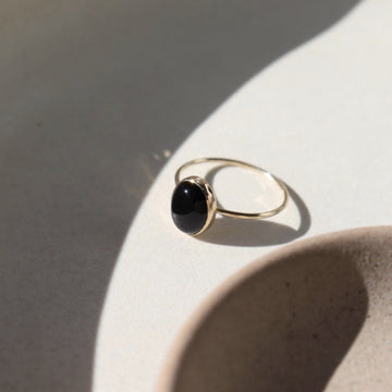 Black Agate Ring - Oval cut black onyx gemstone handset in an oval bezel. Shown in 14k gold fill. Also available in Sterling Silver. By Token Jewelry in Eau Claire, WI Gemstone Jewelry