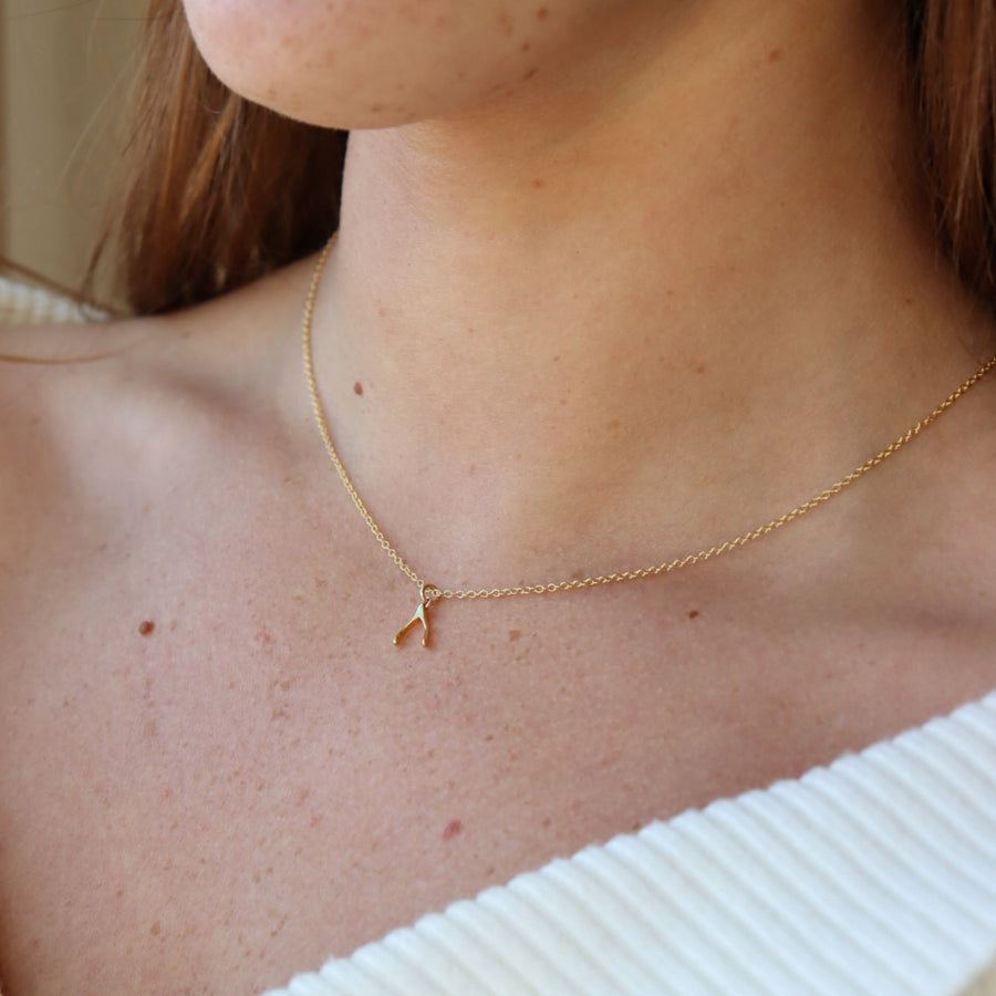 Model wearing 14k gold fill Wishbone Necklace.