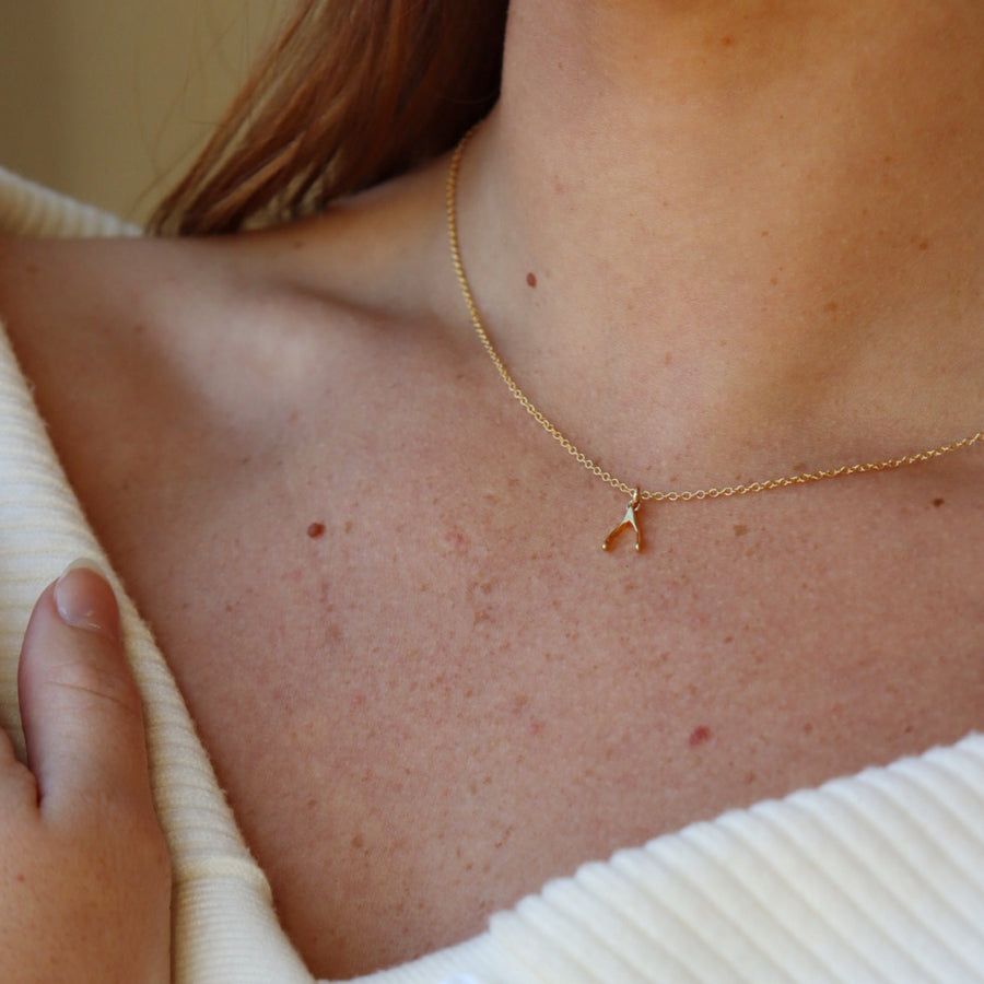 Model wearing 14k gold fill Wishbone Necklace.