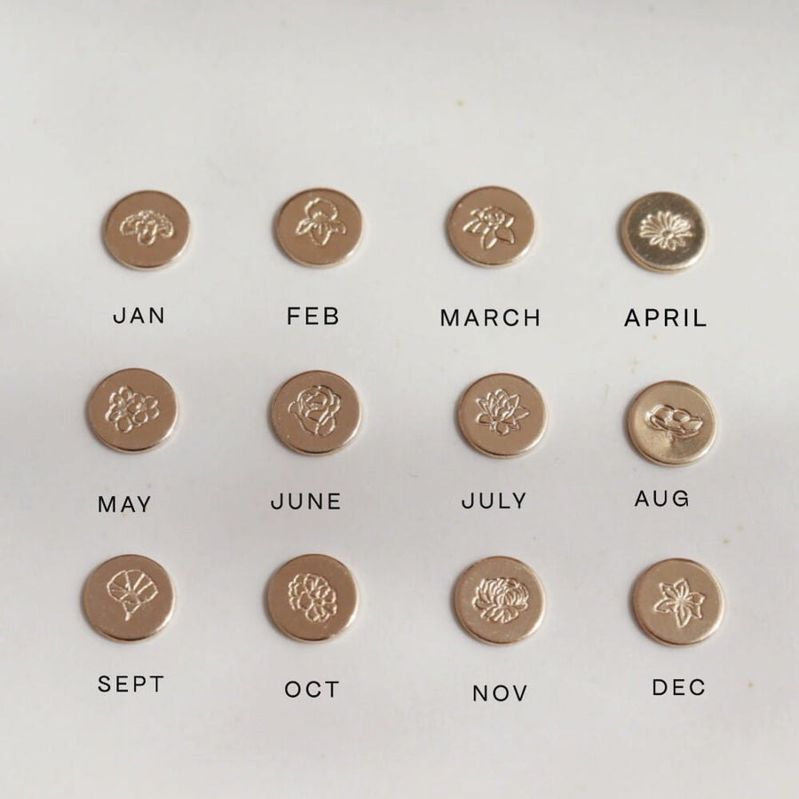 Examples of each birth flower available to be hand stamped onto a keepsake ring, including roses, carnations, daisy, lotus, poppy, among others.
