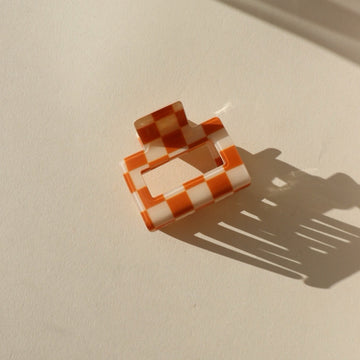 toffee colored checkered hair clip on a sunny background