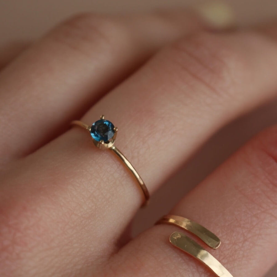 A timeless soft London blue topaz sits on a 14k gold solitaire band, December birthstone, soft blue hue, gift, handmade in eau claire, wisconsin, handmade jewelry, heirloom collection, everyday solid gold, solitaire ring, blue gemstone ring