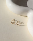 gold fill open heart wire stud earrings on a sunlit tabletop