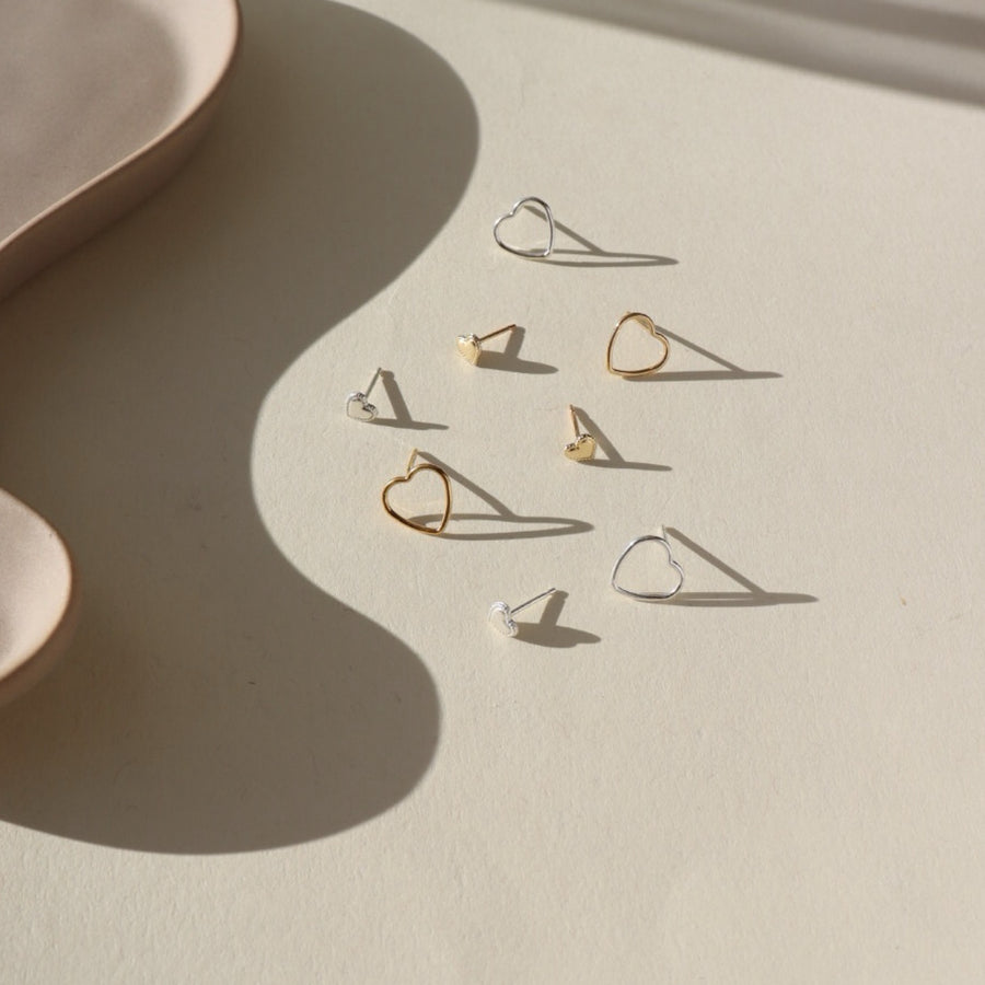 small heart studs with a patterned border, on a ceramic dish