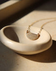 Sunrise Necklace - Token Jewelry - hand cut 14k gold fill or sterling silver sheet metal - half circle sunrise horizon shape - hanging from chain - locally handmade in our Eau Claire, WI studio - Token Jewelry