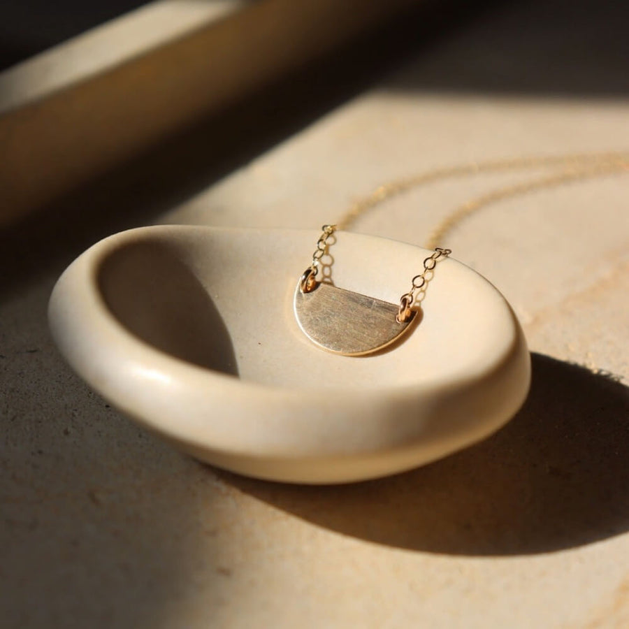 Sunrise Necklace - Token Jewelry - hand cut 14k gold fill or sterling silver sheet metal - half circle sunrise horizon shape - hanging from chain - locally handmade in our Eau Claire, WI studio - Token Jewelry