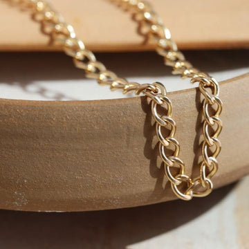 Bold and chunky 14k gold filled curb chain with a lobster clasp and 2" extender chain to make the necklace adjustable from 14" to 16". Alexandra Choker, handmade by Token Jewelry in Eau Claire, WI  jewelry store near me, permanent jewelry, jewelry repair near me, rings, earrings, necklace, bracelet, gold chain, gemstones, rose gold