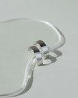 Sterling silver arc studs set on top of a clear plate. hand made in Eau Claire, WI.