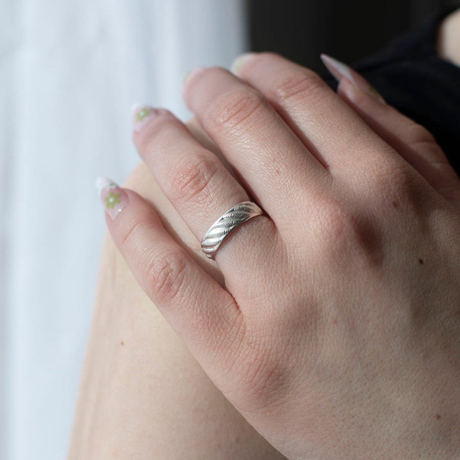 925 sterling silver ripple textured ring photographed on a model