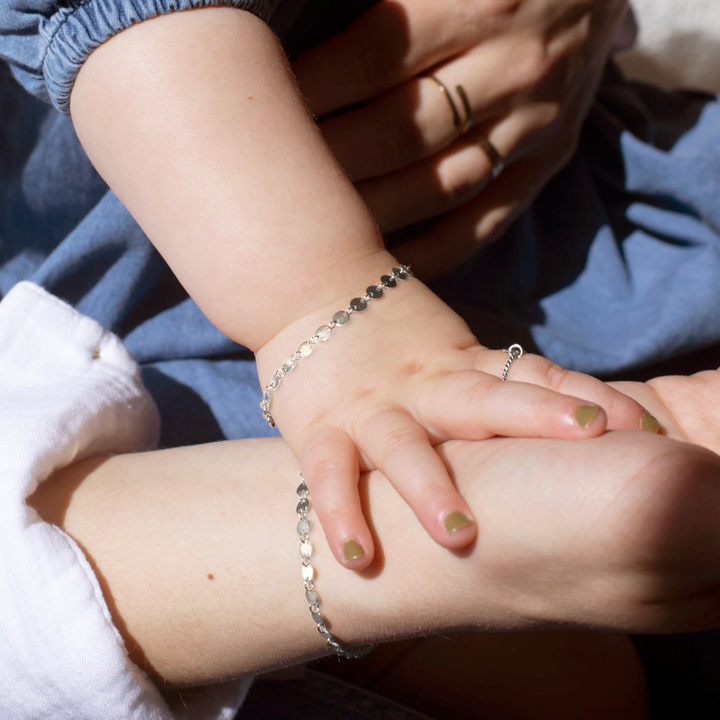 mother and daughter's hands wearing matching 925 sterling silver starlight bracelets